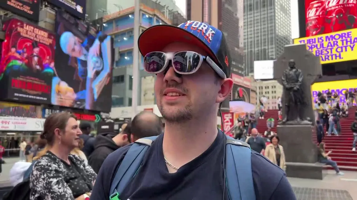 A passerby trying on a client's AR glasses in Times Square, New York